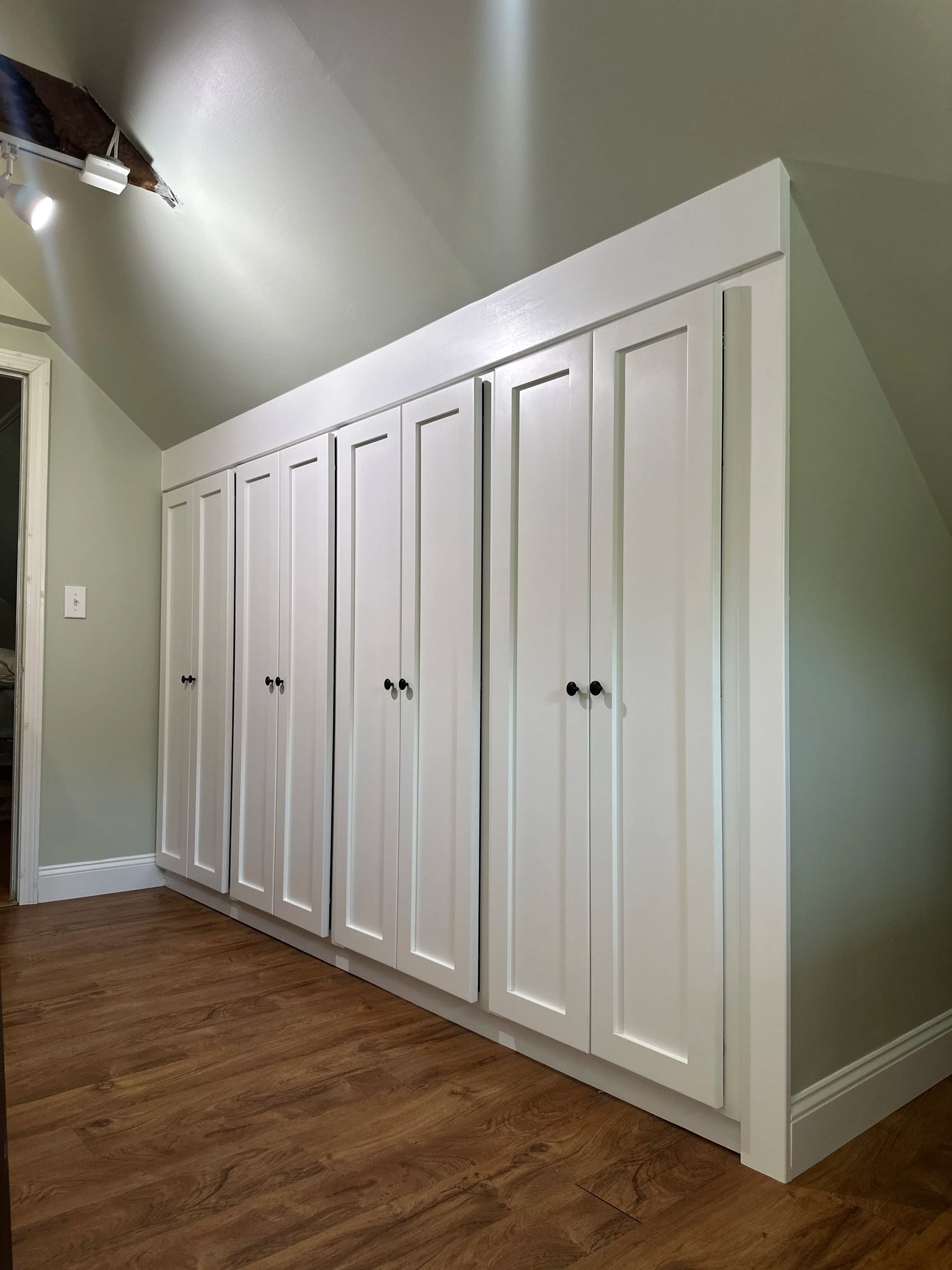 Project Custom Built-In Cabinetry Designed for a Tricky Sloped Ceiling Space image